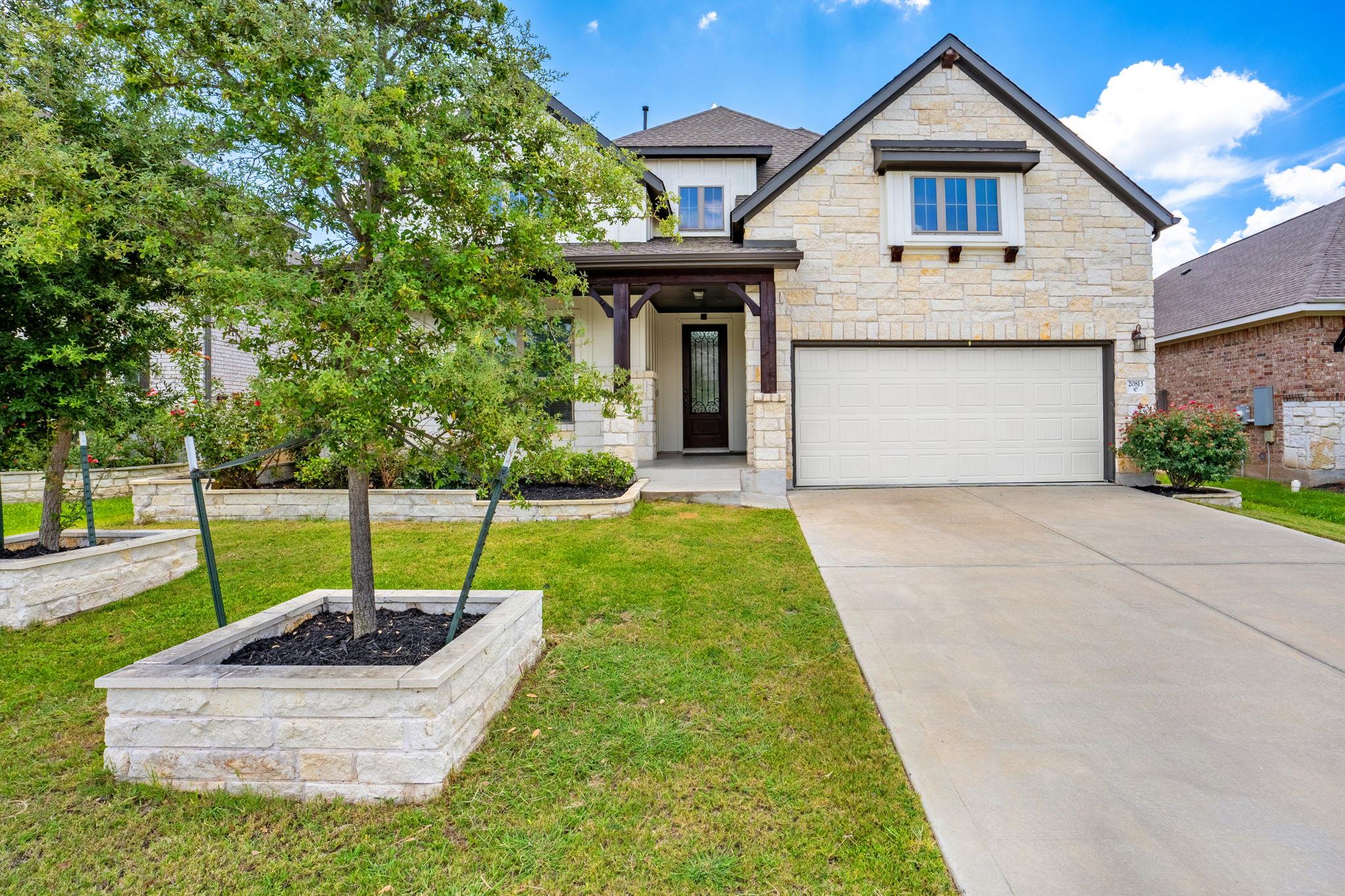 Natural stone masonry and a concrete driveway def