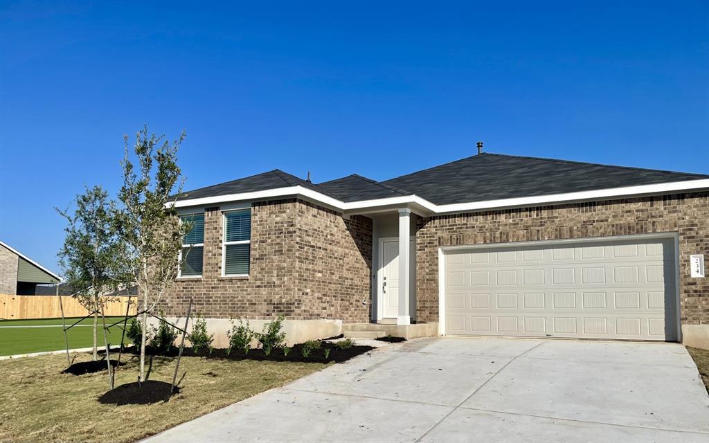 A classic brick exterior and a concrete driveway 