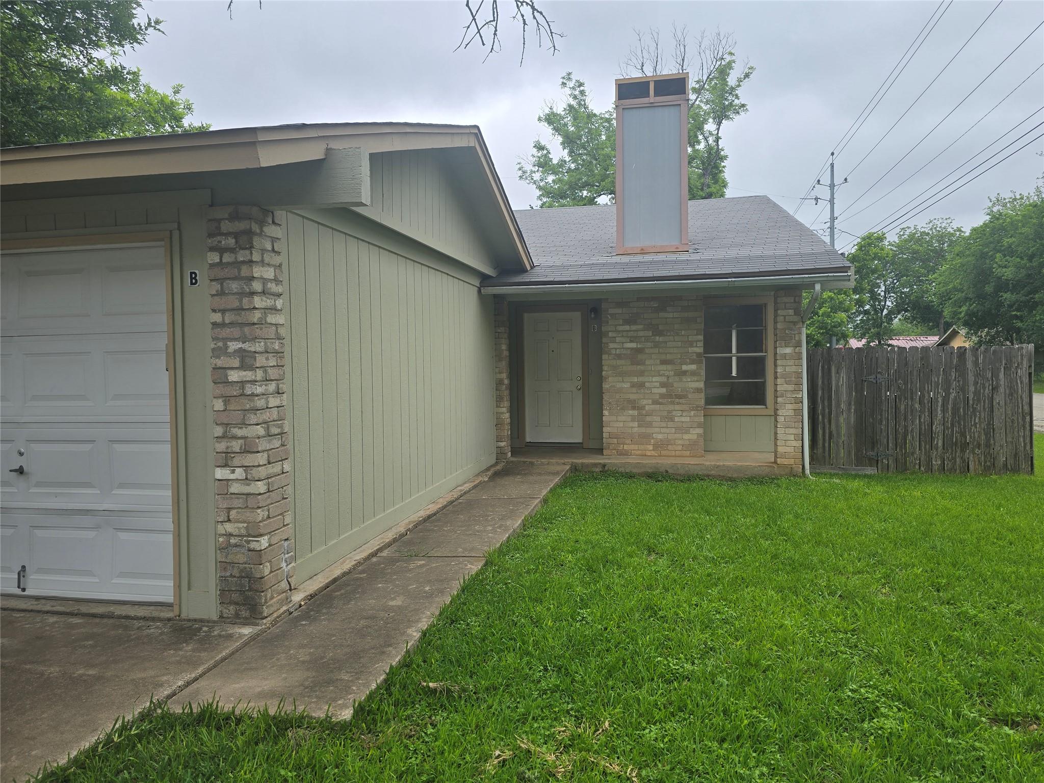 Brick and vertical siding exterior featuring an a