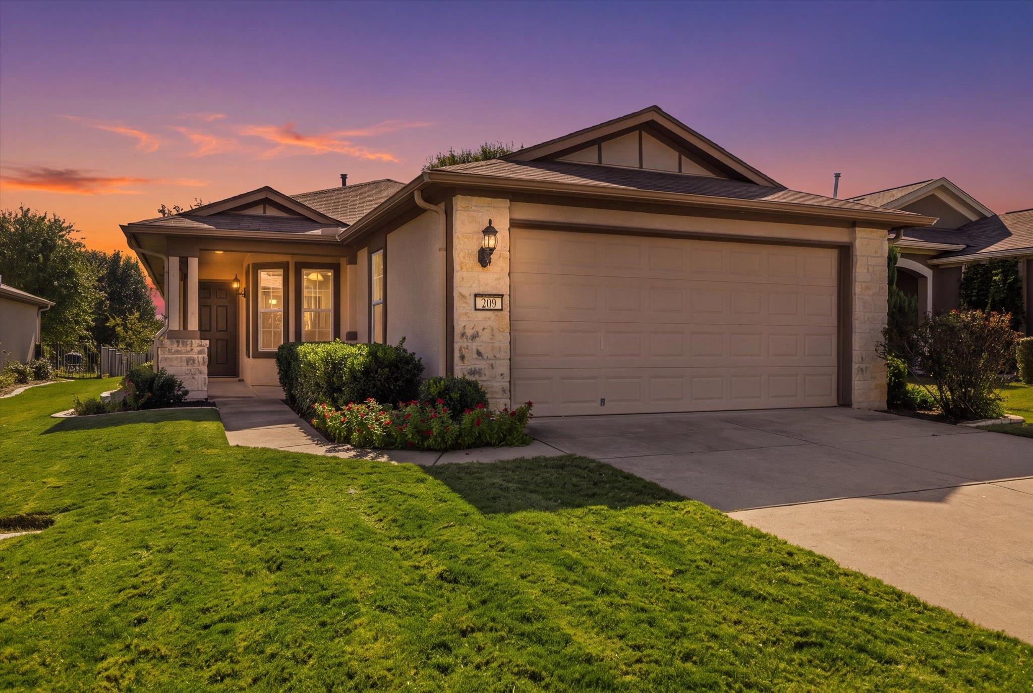 A concrete driveway leads to this classic home fe