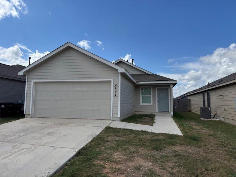 A classic concrete driveway and walkway lead dire