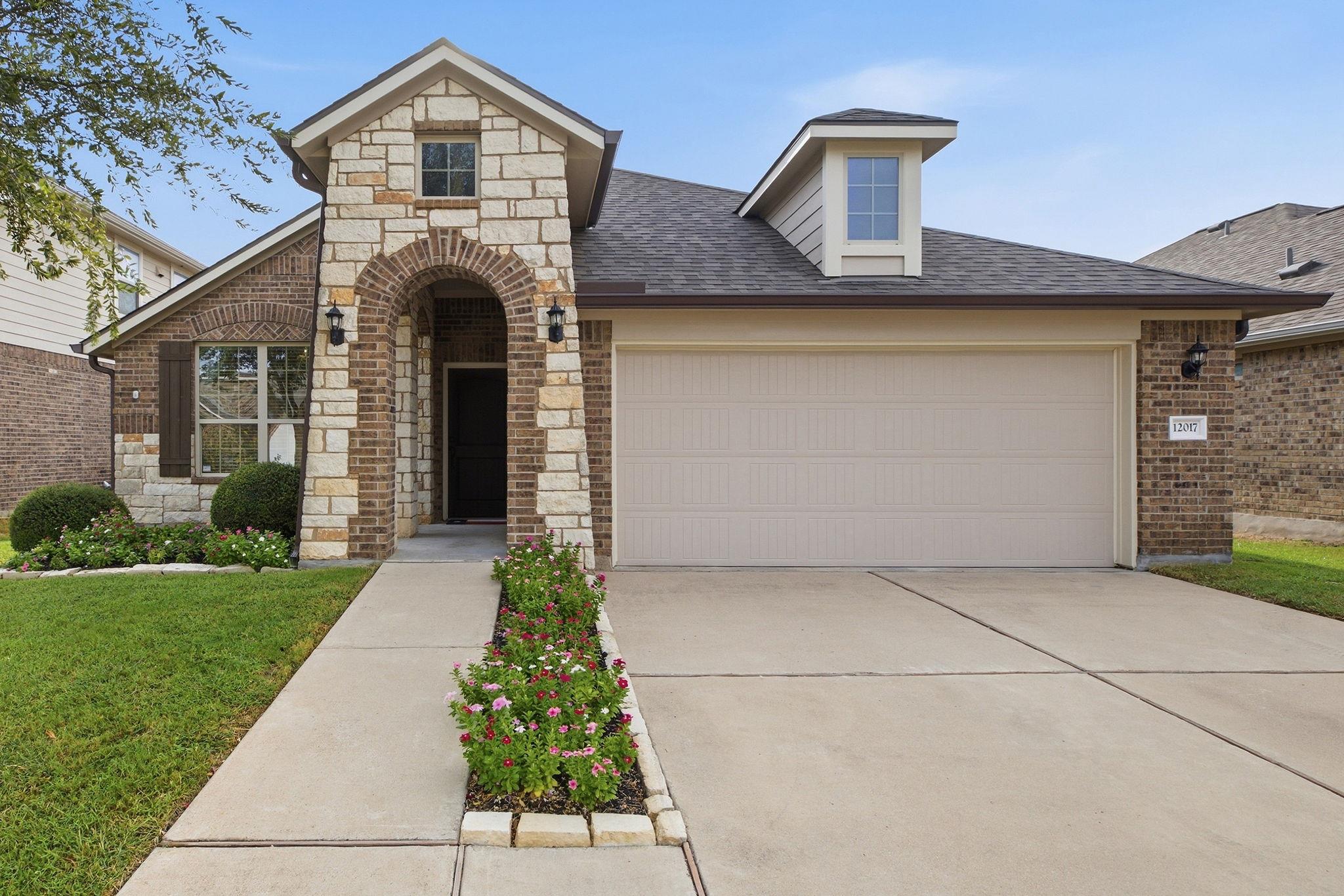 Textured stone accents and a classic brick facade