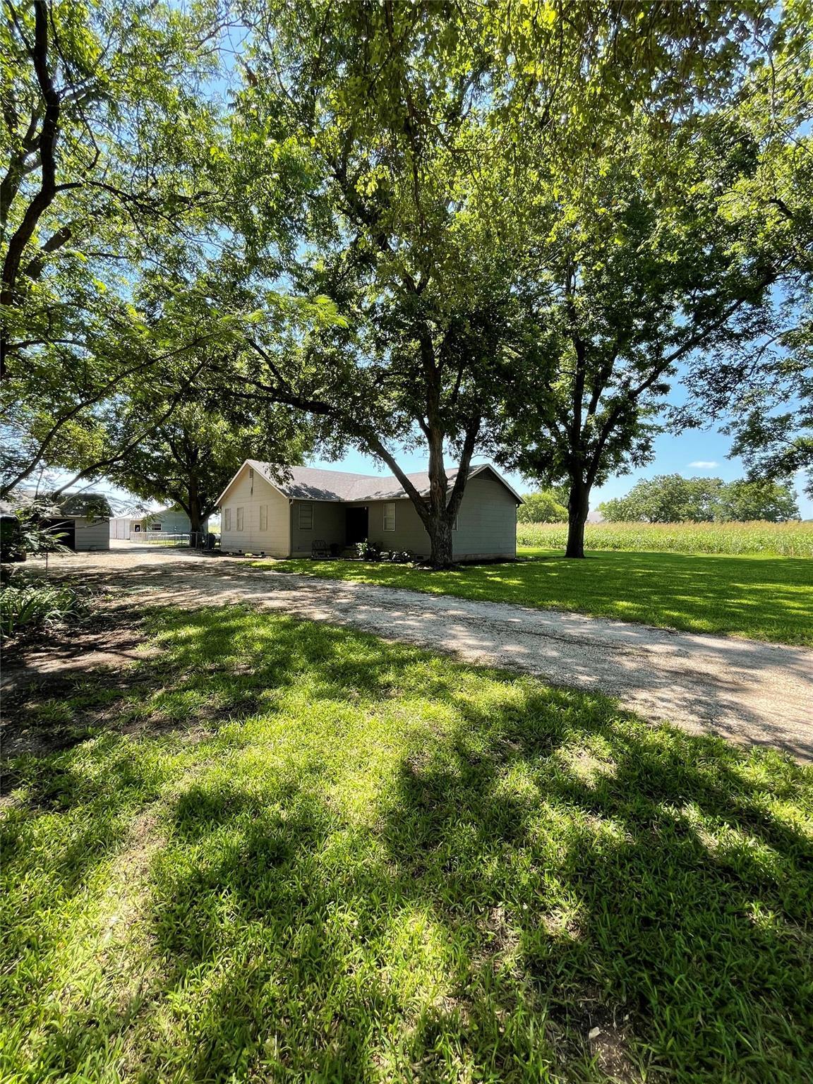 Mature shade trees frame a charming ranch home ne