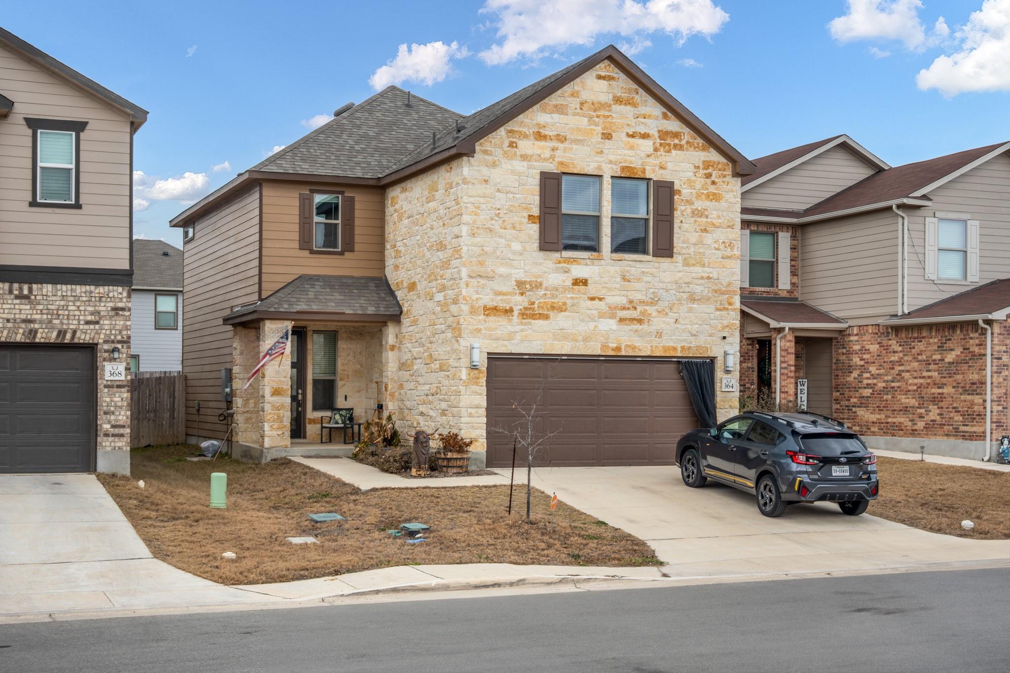 A striking stone facade and covered entryway crea