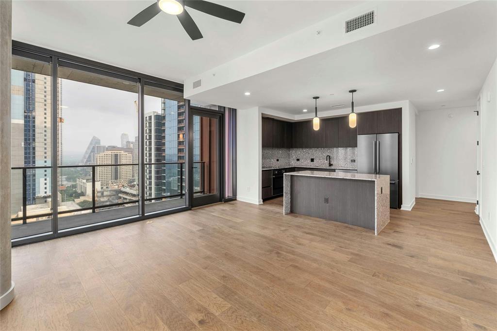 Floor-to-ceiling windows illuminate the open livi