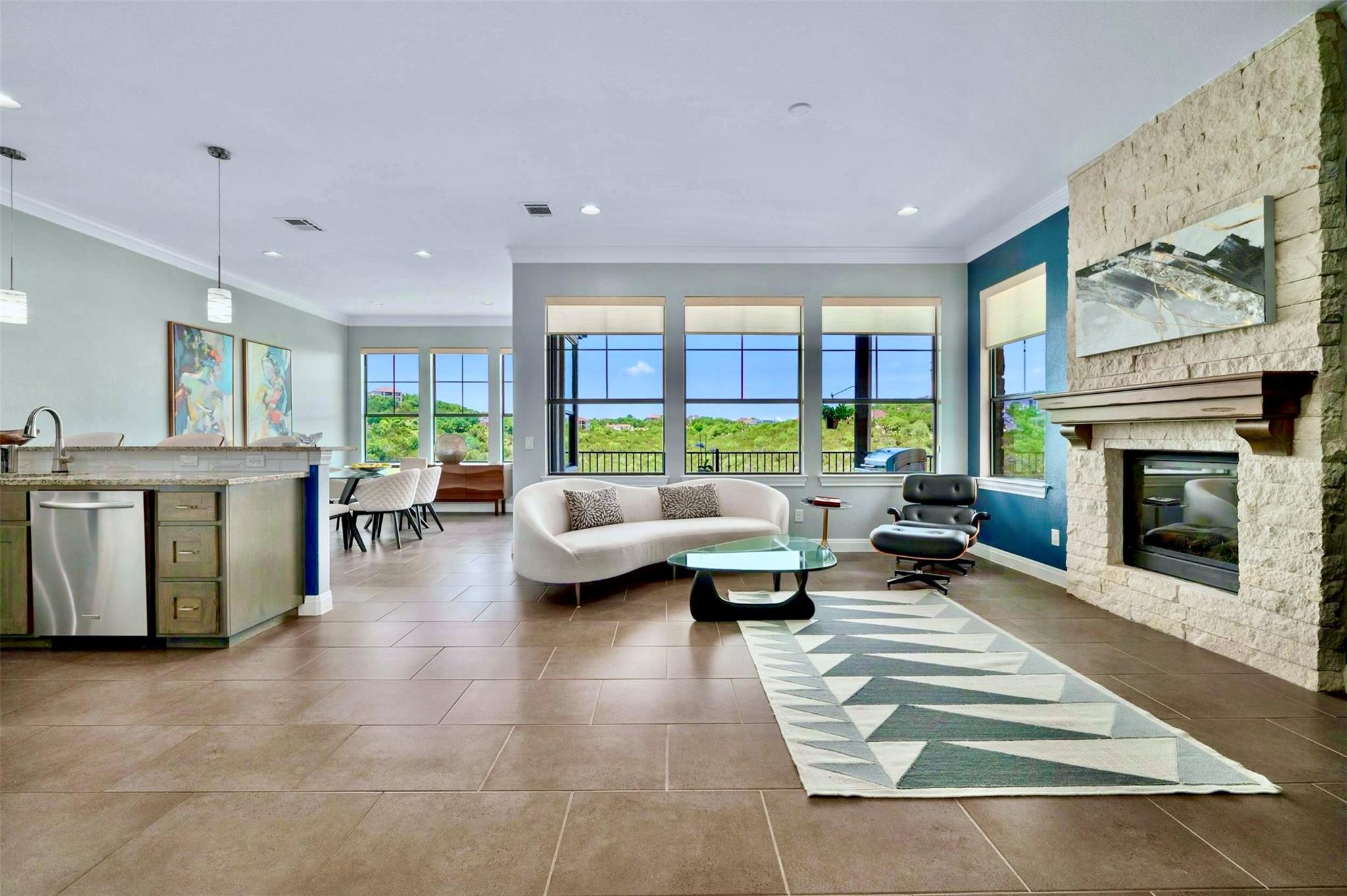 A stone fireplace anchors this open living space 