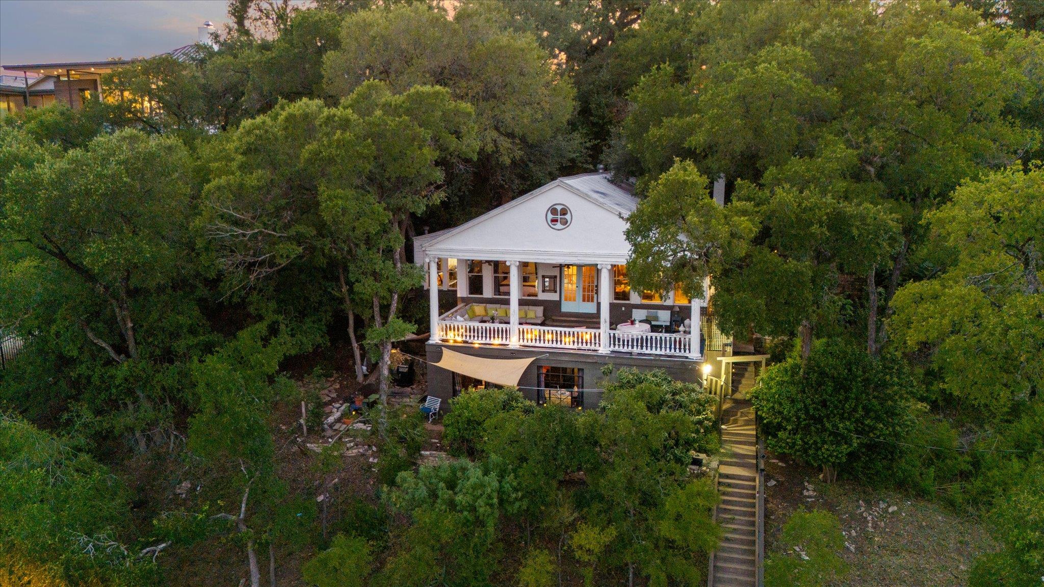 Mature trees frame a classic multistory home feat