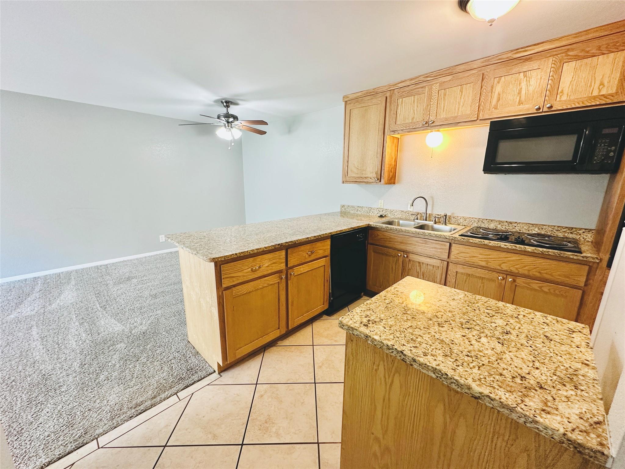 Stone countertops and classic wood cabinetry enri