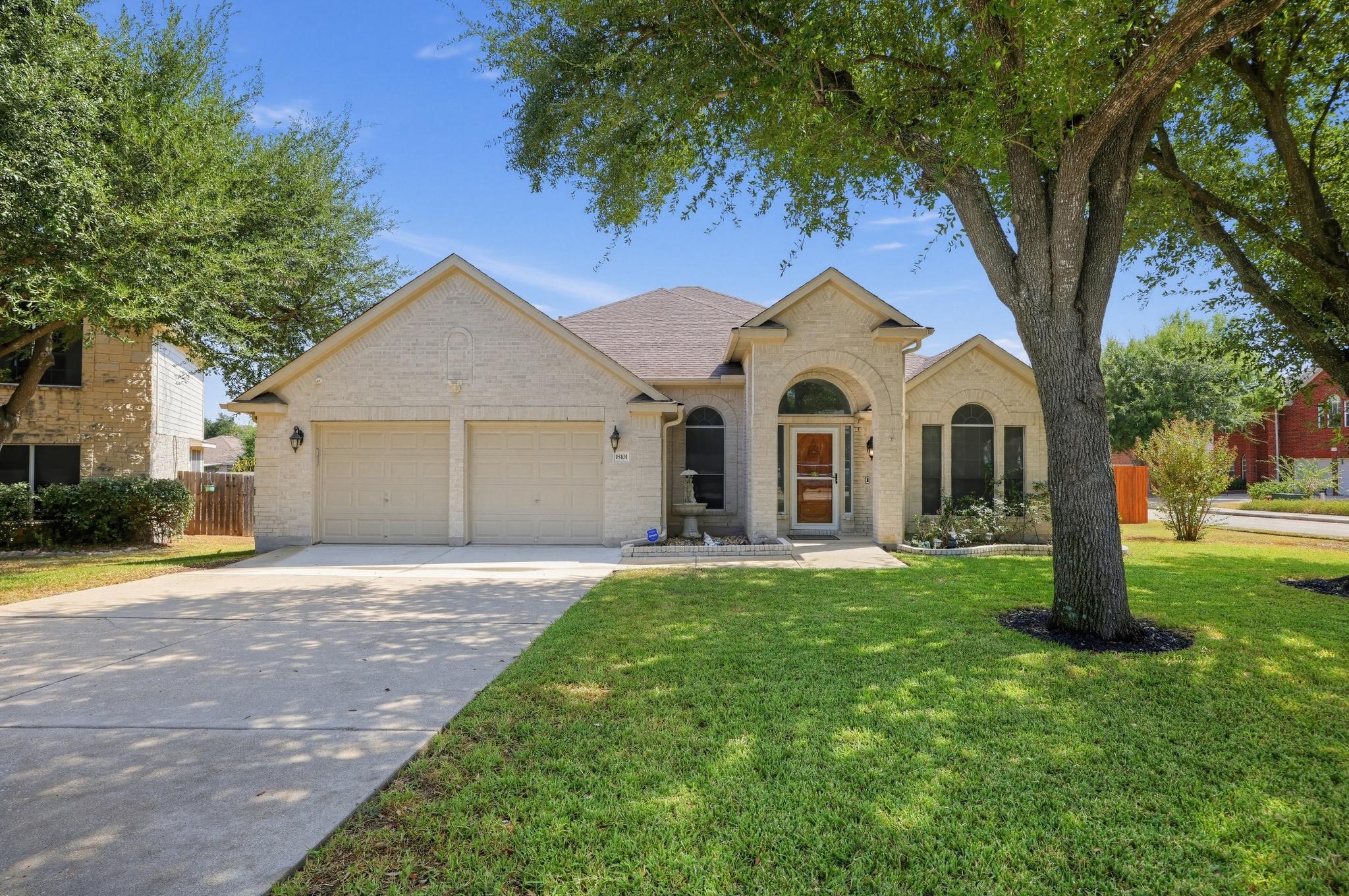 Stately brick arches and mature shade trees frame