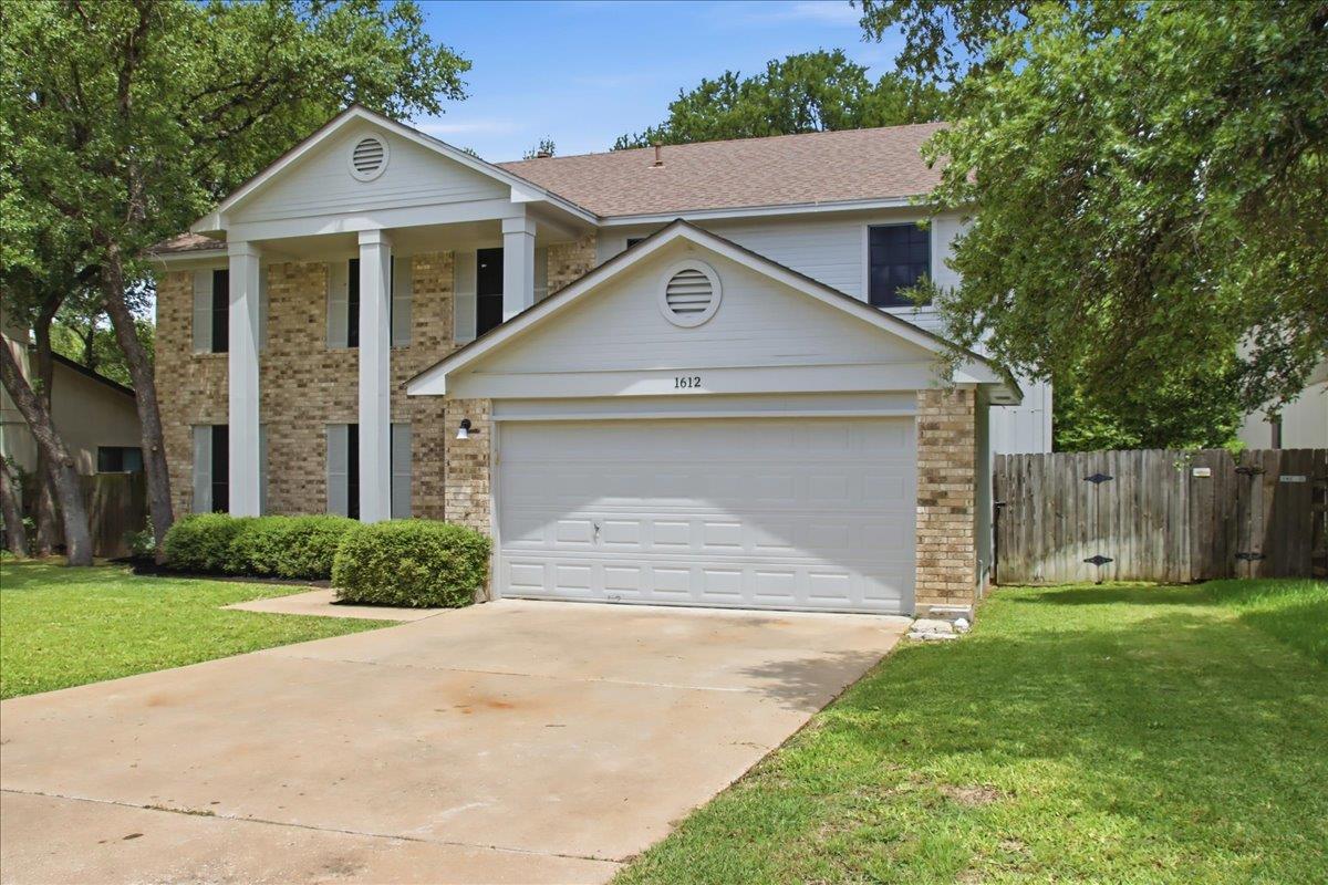 Stately columns and classic brick veneer define t
