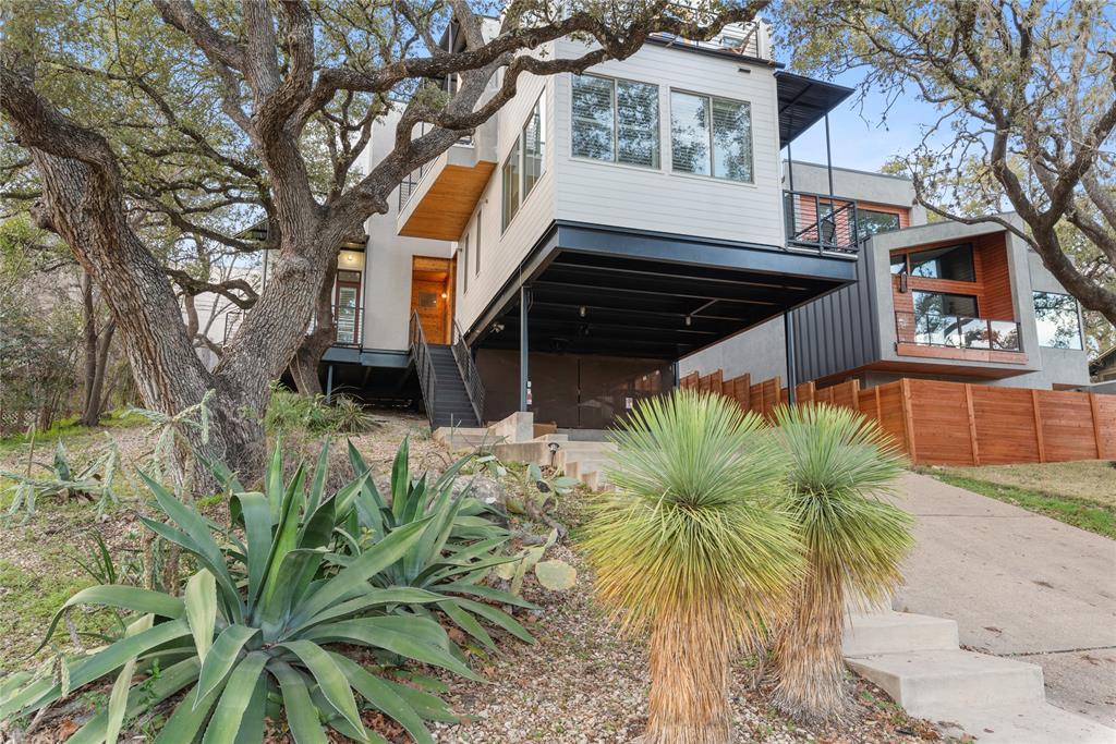 Mature trees and native landscaping frame this mo