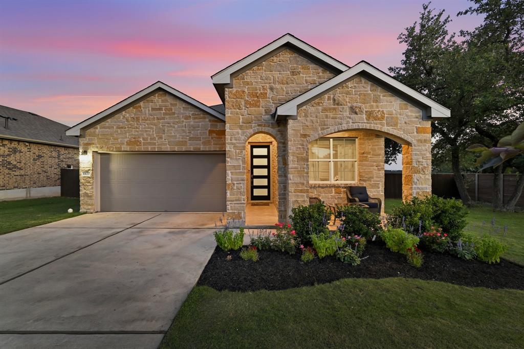 Natural stone masonry anchors the exterior facade