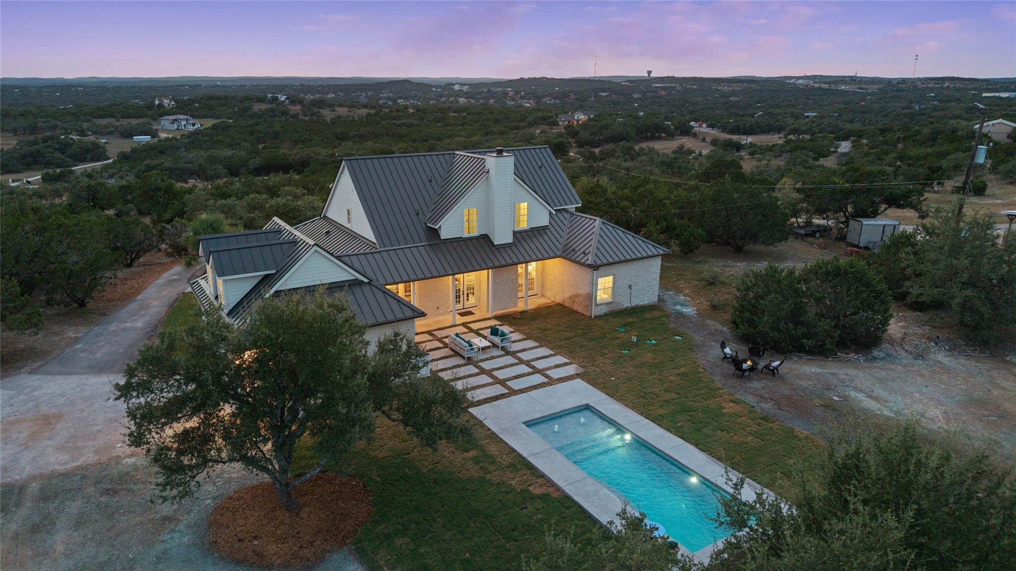 An inviting swimming pool and paved patio highlig