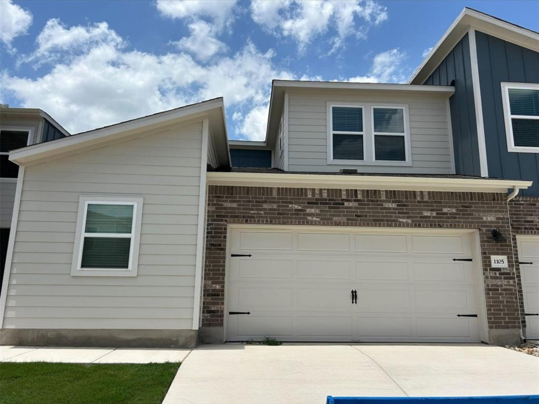Clean lines and a blend of brick and siding defin