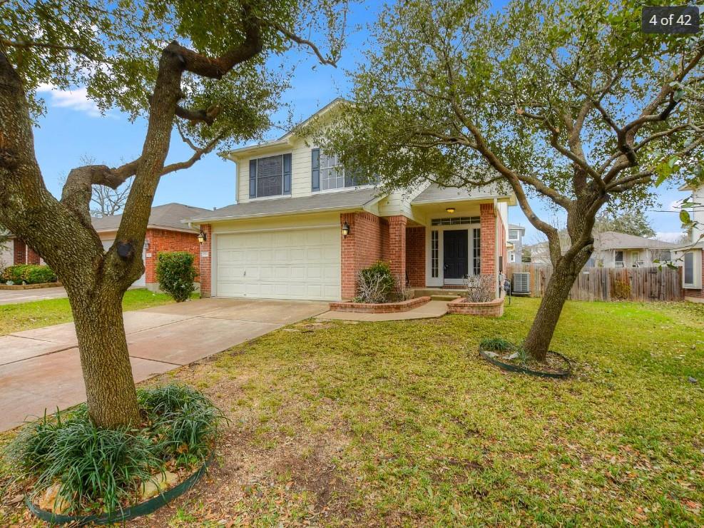 Mature trees shade the brick and siding exterior 