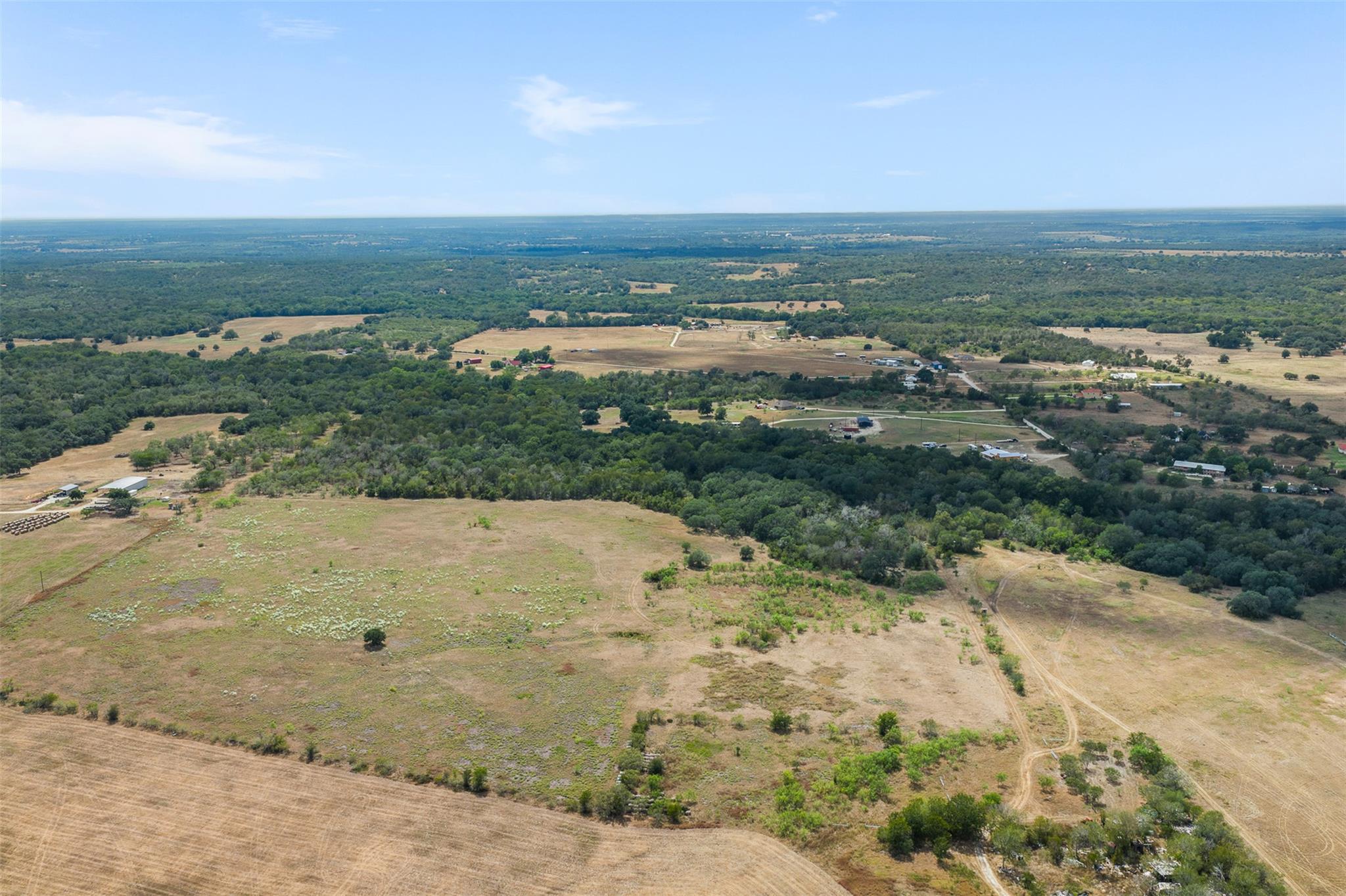 Gently rolling pastures and dense woodlands stret