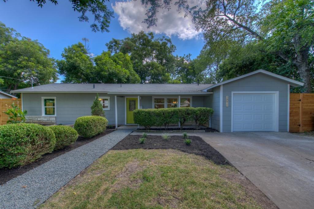 Mature trees frame a classic single-story exterio