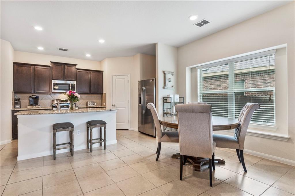 An open layout connects the tiled breakfast area 