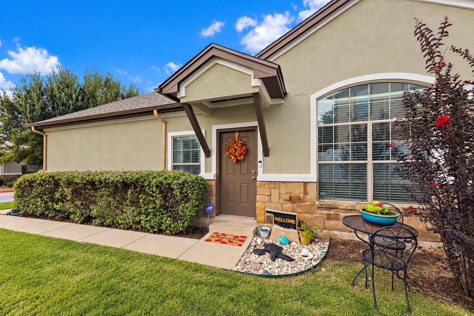 Stucco and stone finishes complement the welcomin