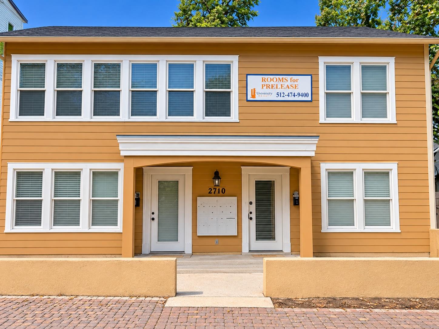 A symmetrical facade features horizontal siding, 