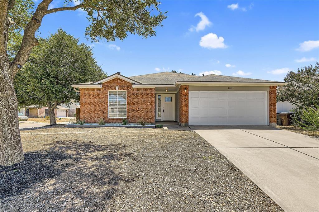 A well-maintained brick facade home awaits, featu