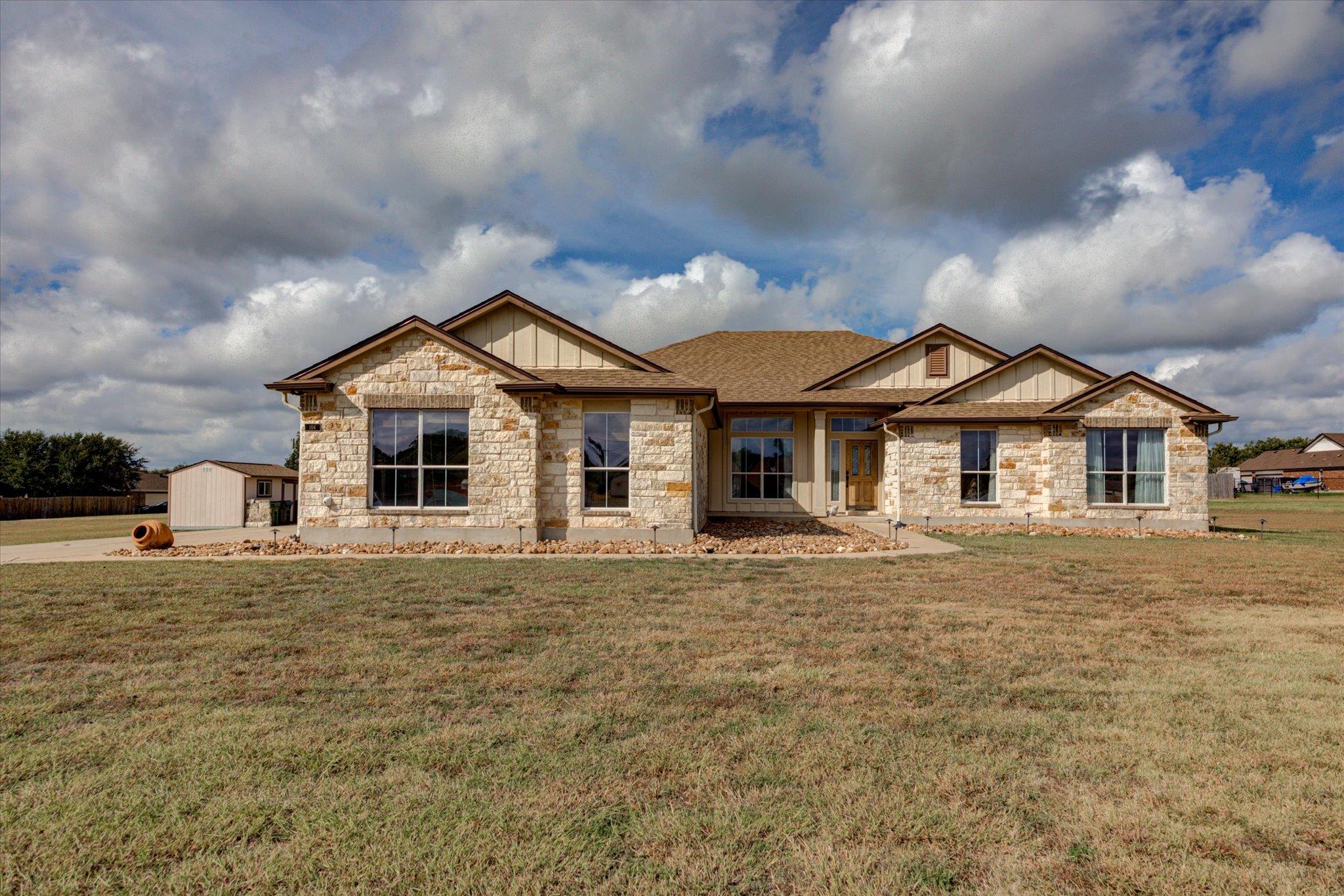 Natural stone masonry and multiple gables define 