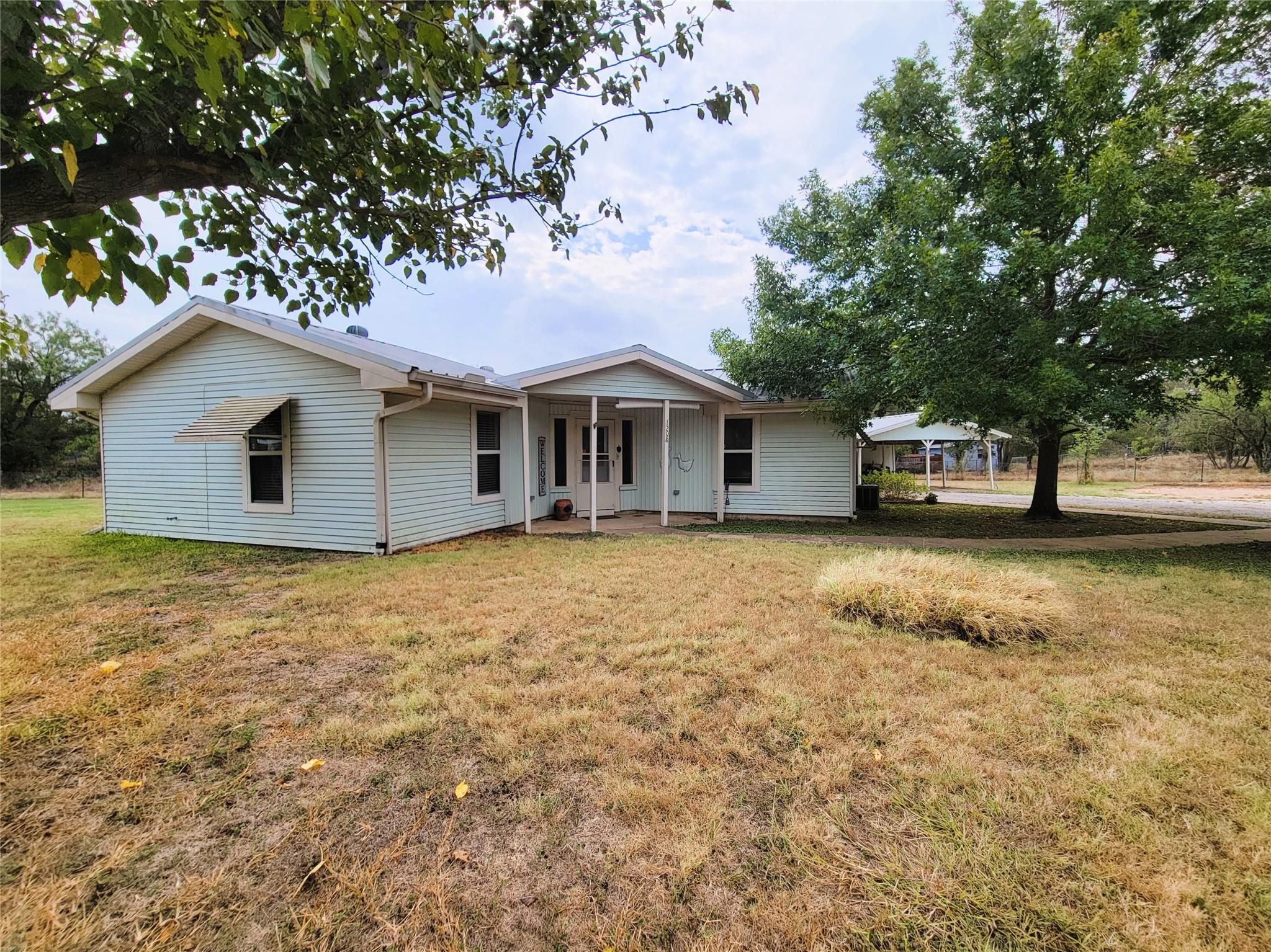 Mature trees shade the front lawn of this classic