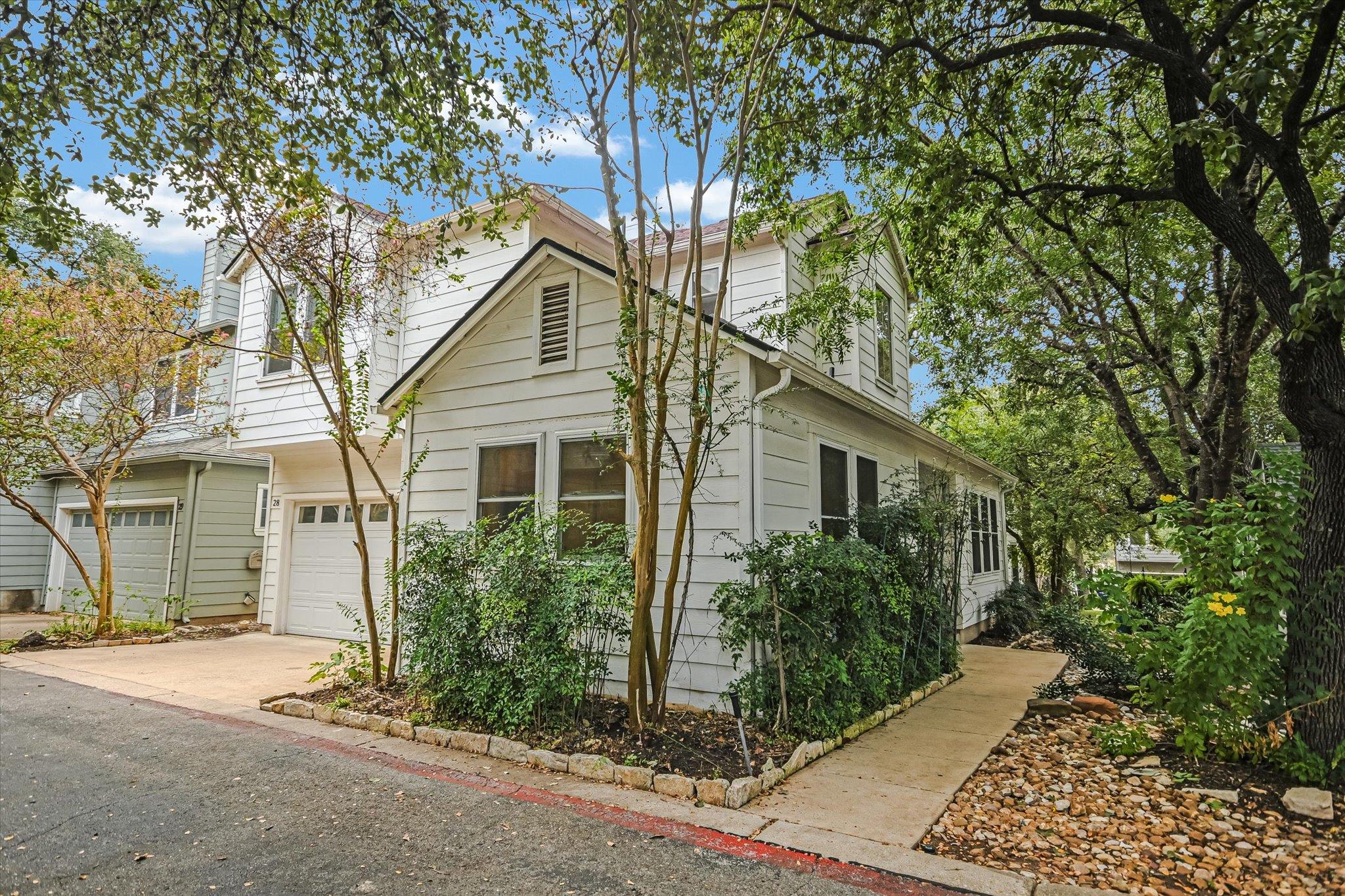 Mature trees shade a charming multi-level exterio