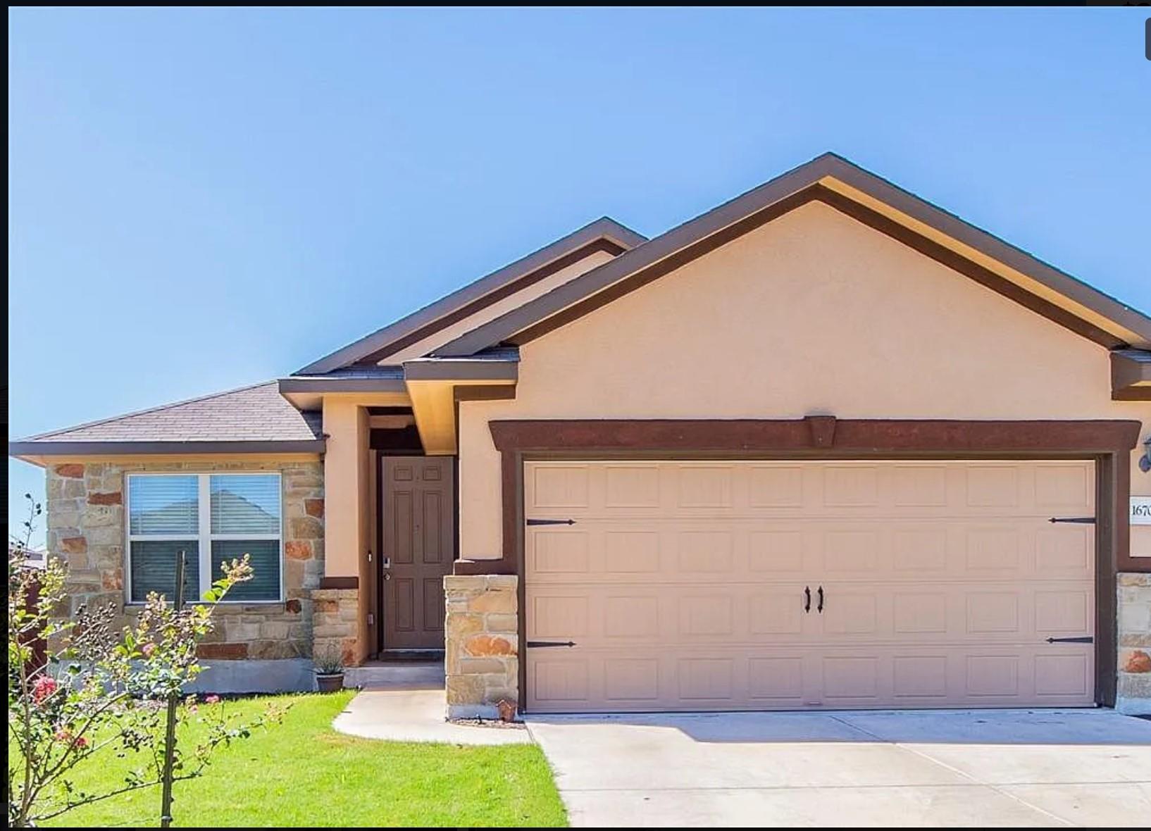 A classic facade blends stucco and stone accents 