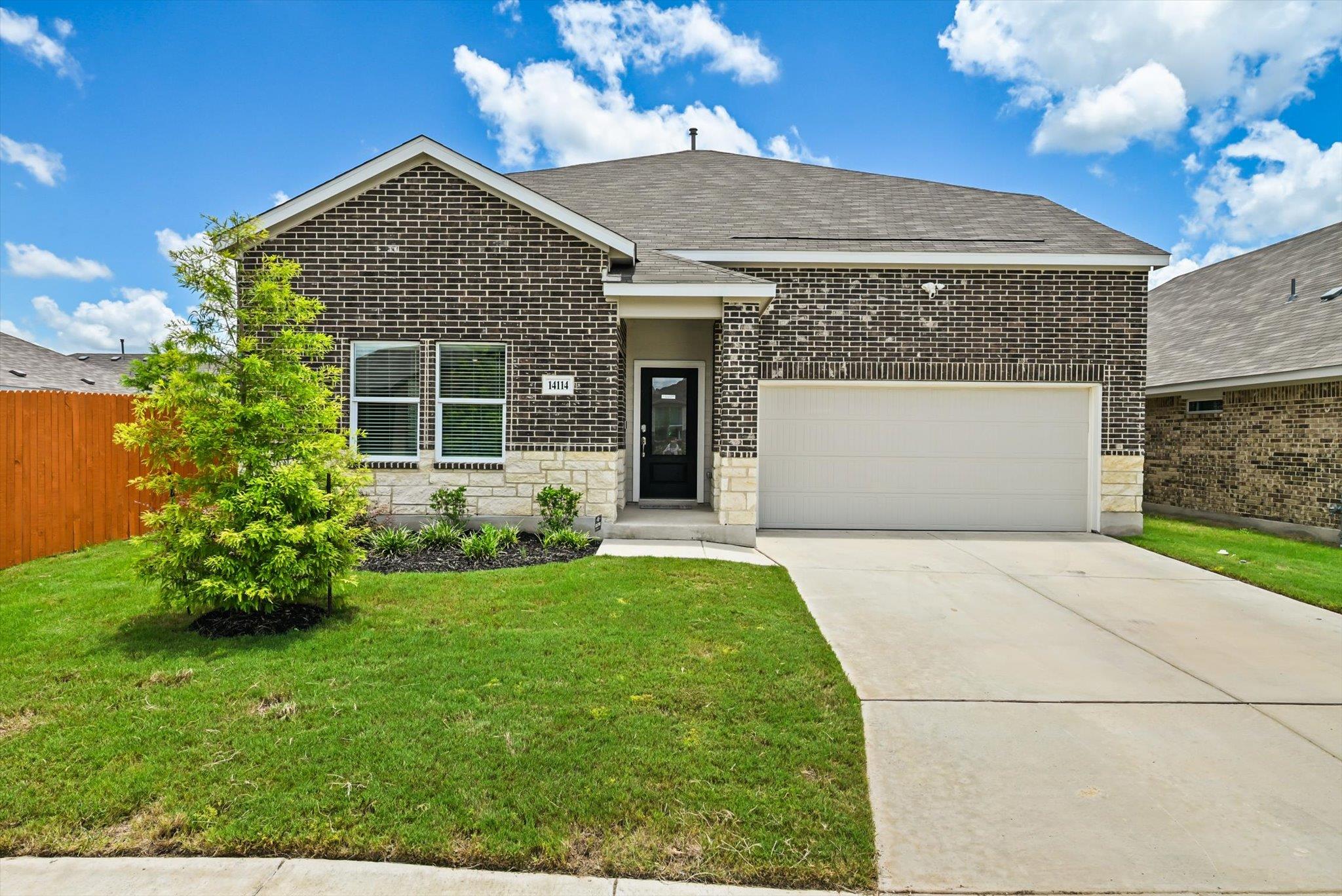 A classic brick exterior and concrete driveway de