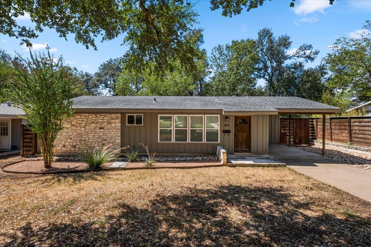 Mature trees shade a classic single-story exterio