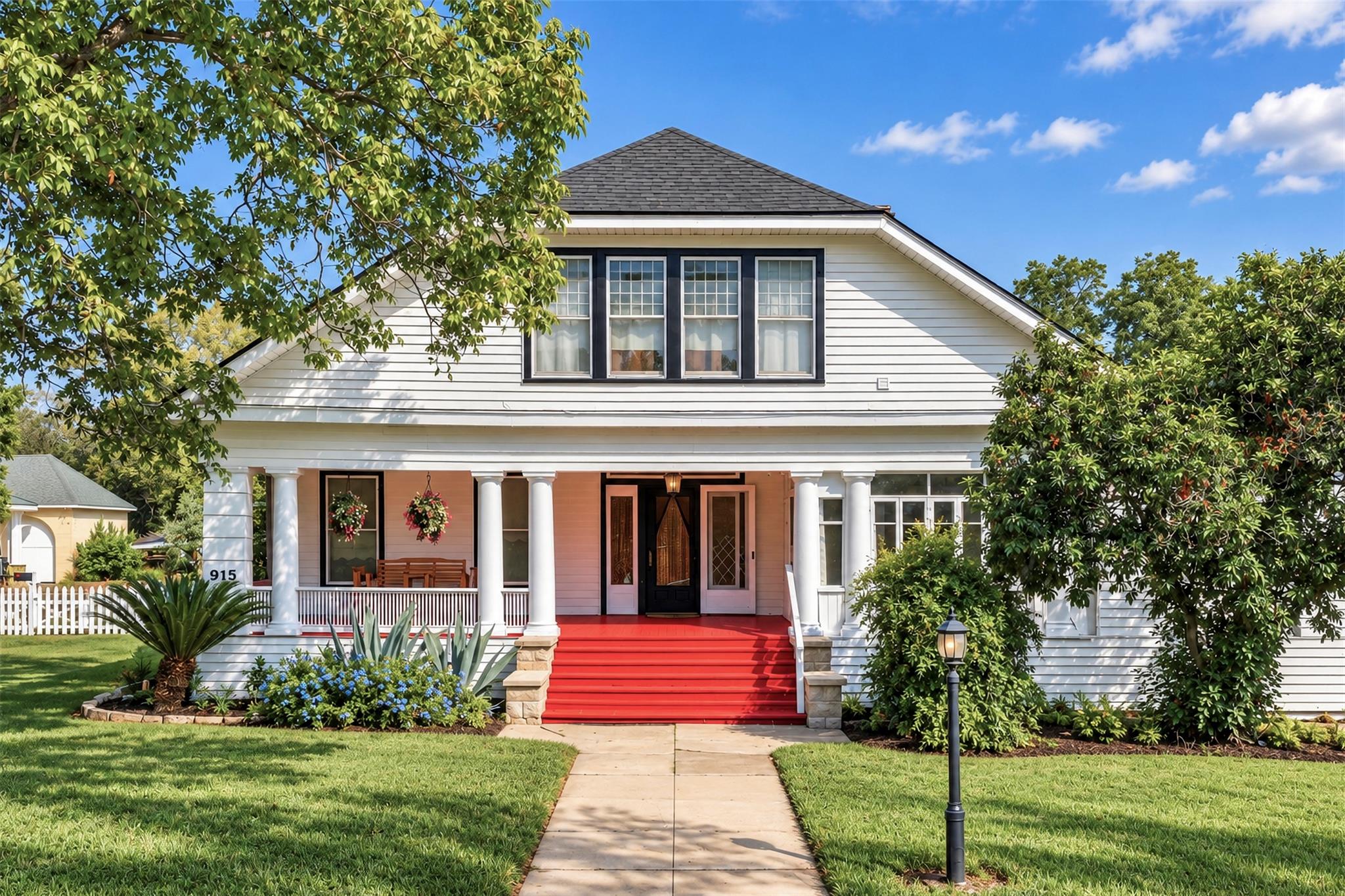 Classical columns support the wide front porch of