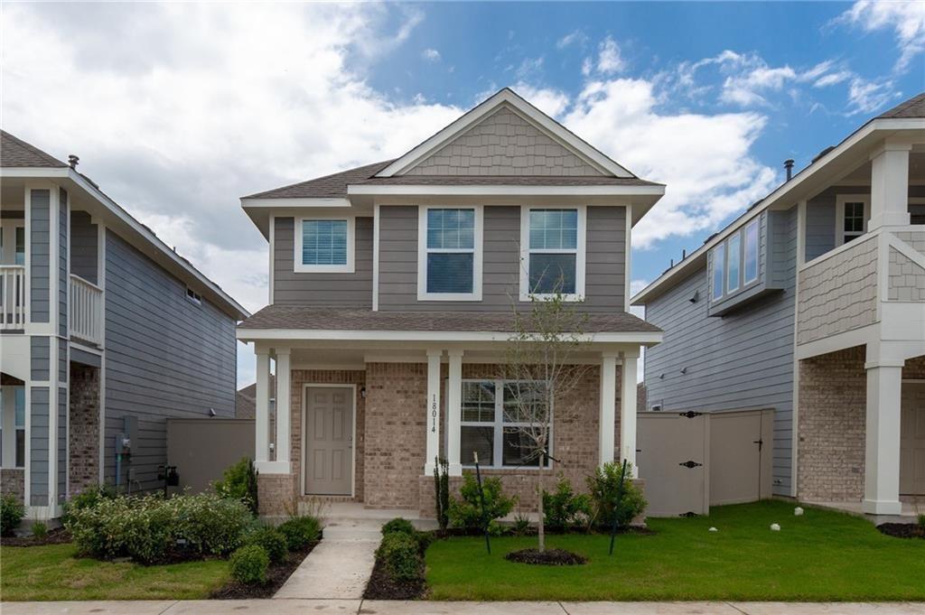 Crisp trim accents the classic siding and brick f