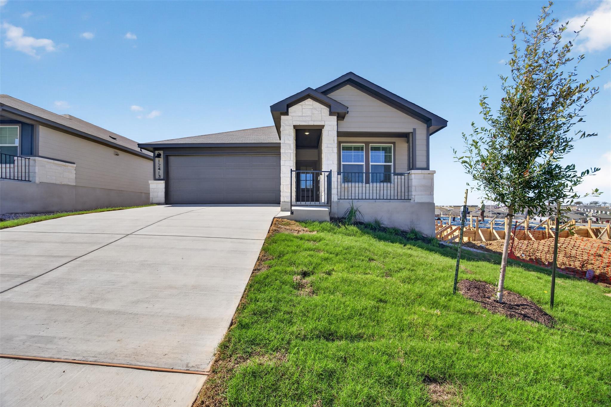 An inviting stone-accented exterior displays a wi