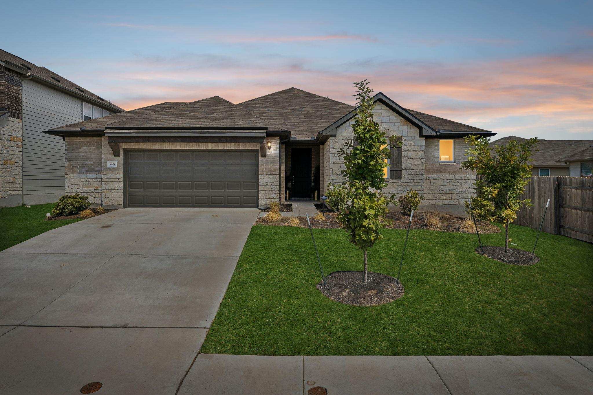 Textured stone veneer and a spacious concrete dri