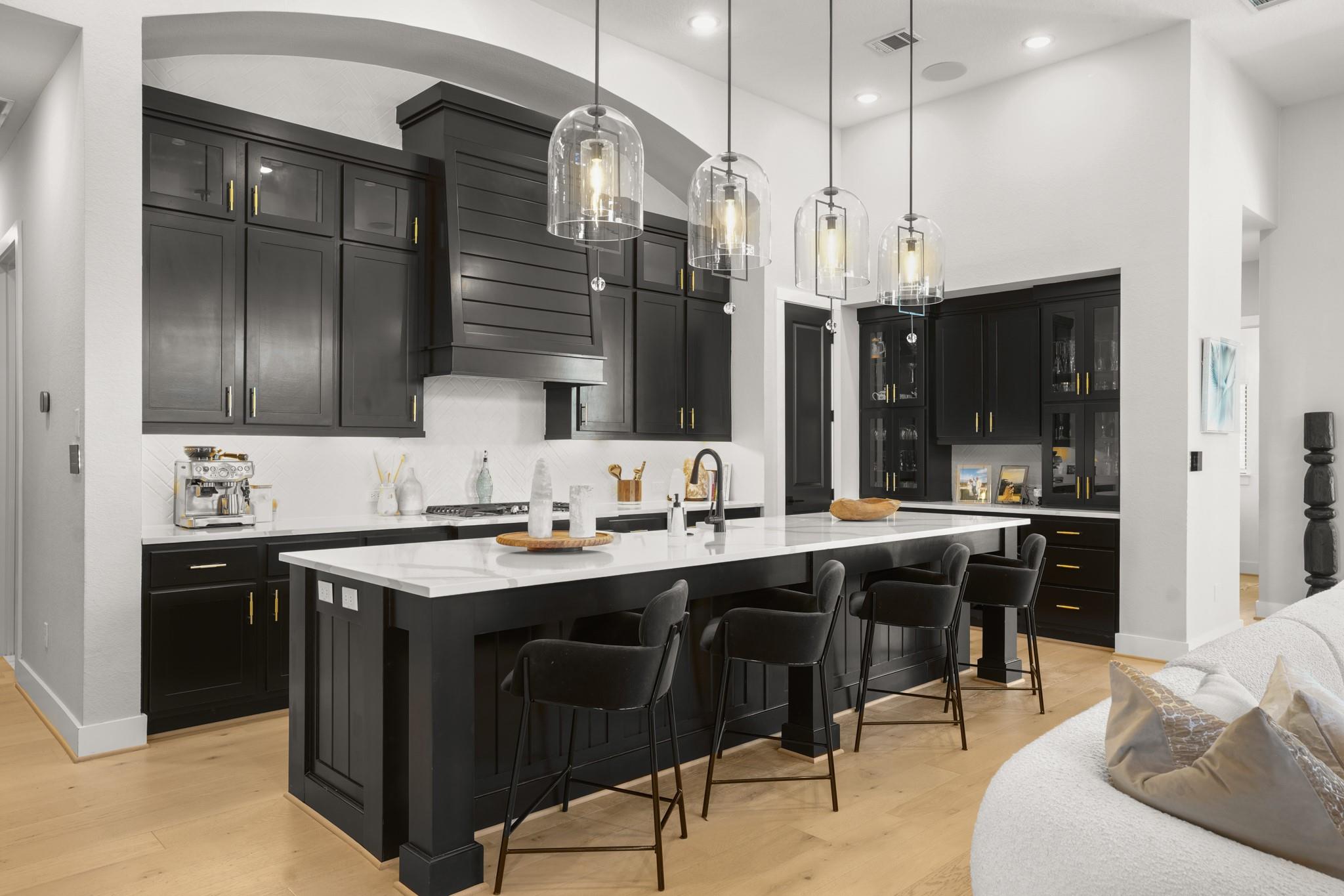 Dramatic dark cabinetry contrasts beautifully wit
