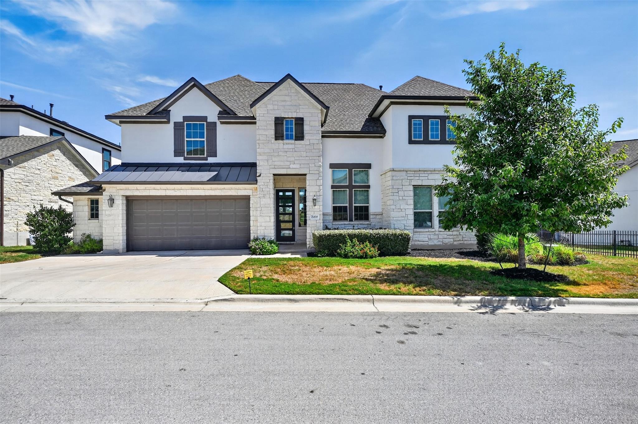 An elegant stone and stucco elevation pairs with 