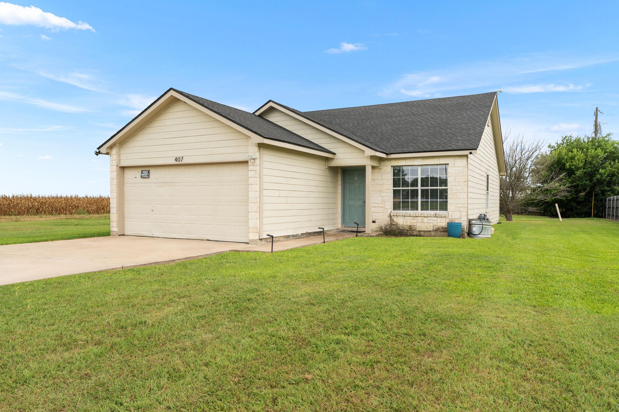 A classic ranch exterior with a wide driveway and