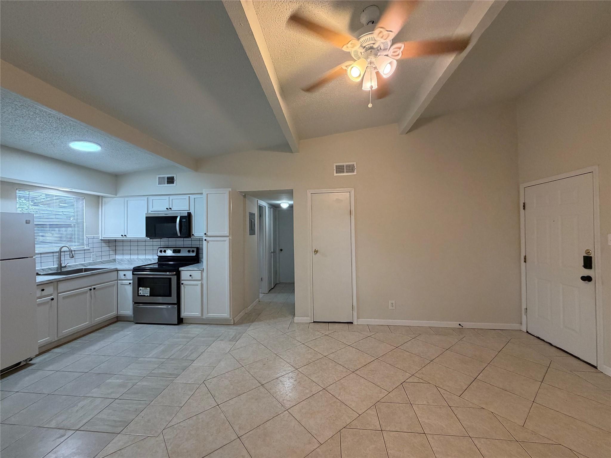 Tiled flooring flows through an open-concept spac
