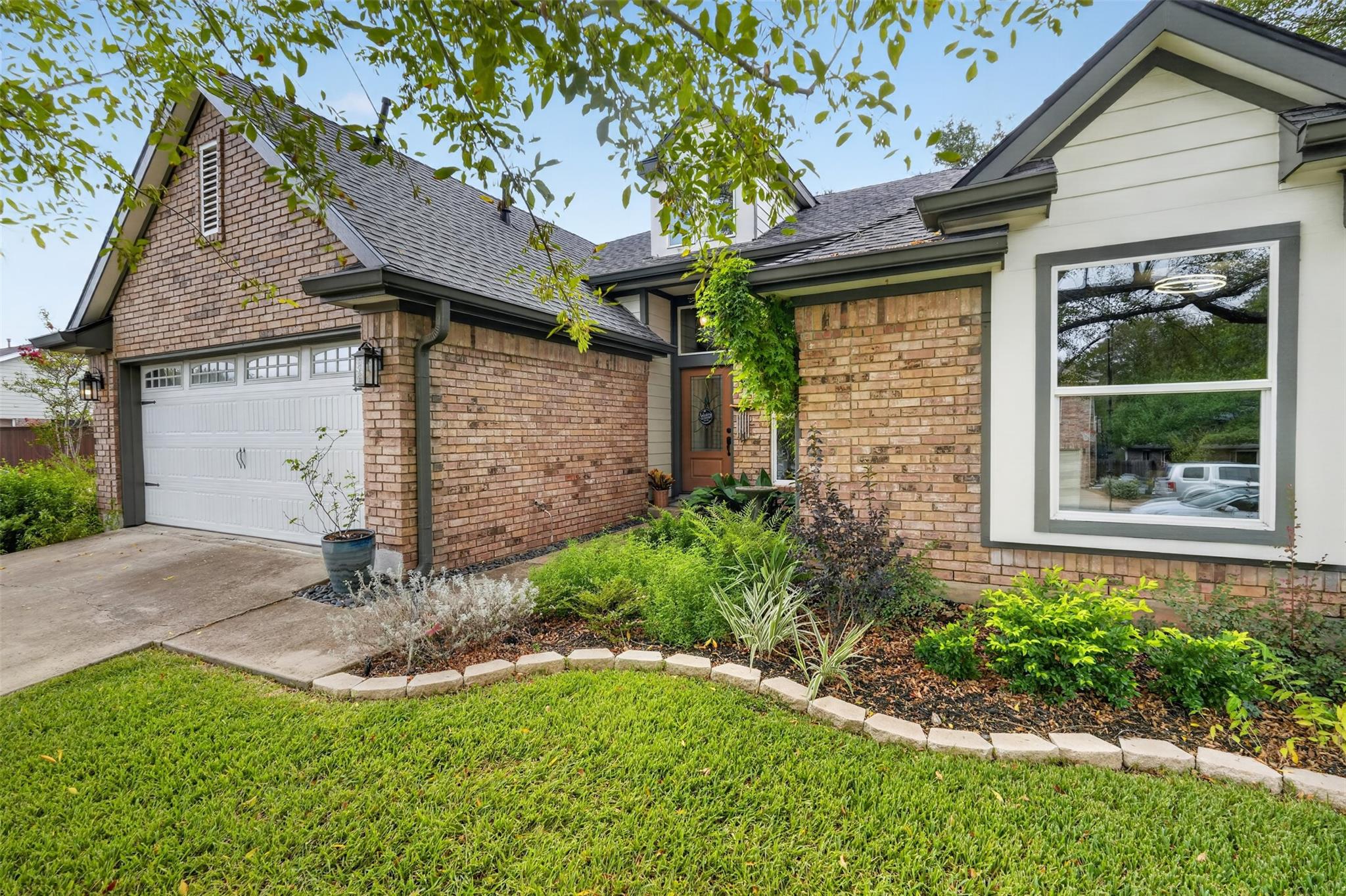 Handsome brick detailing and manicured garden bed