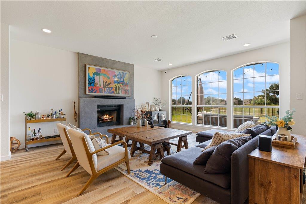 Arched windows frame manicured green views in thi