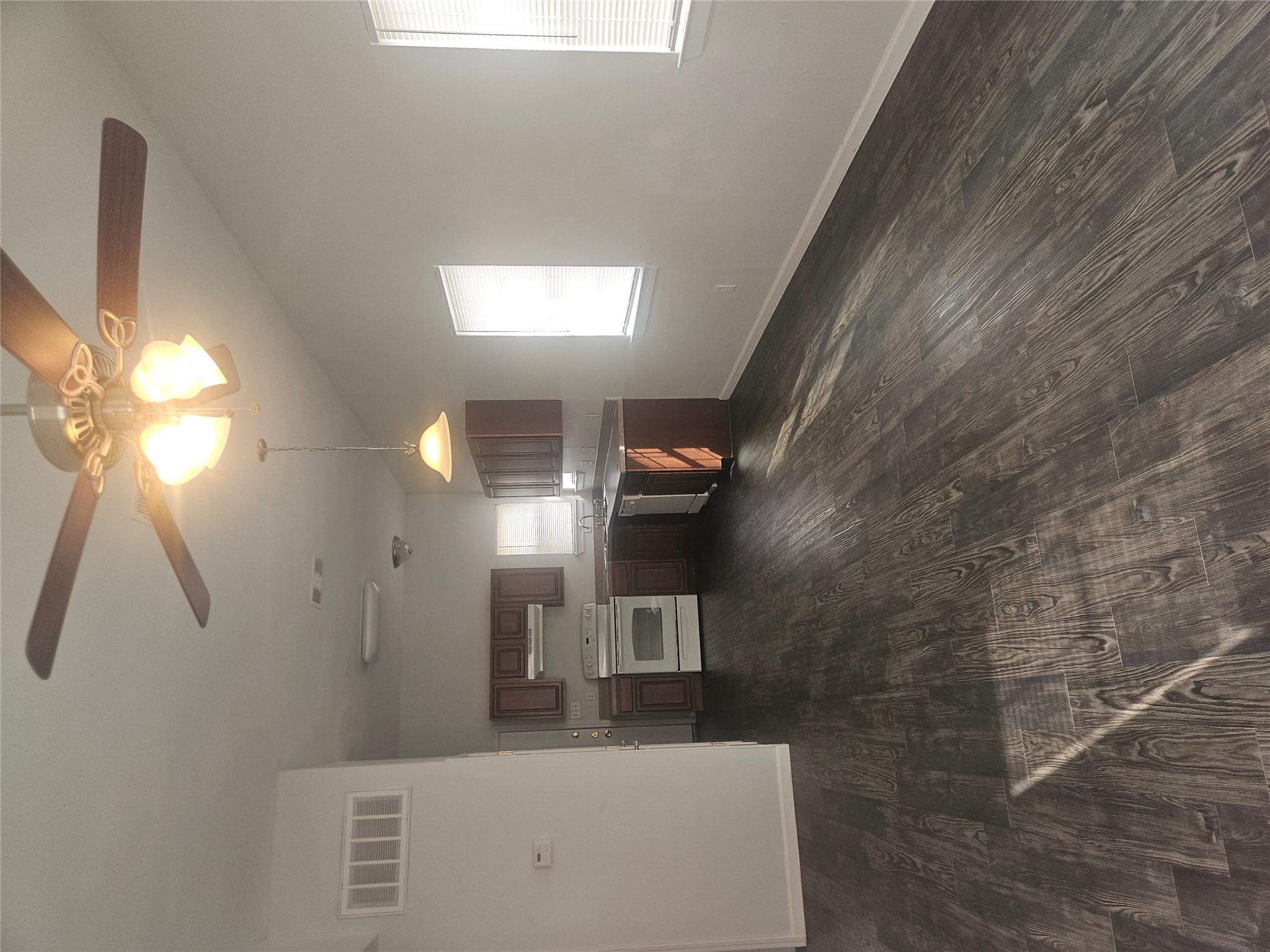 Rich dark wood-look flooring stretches throughout