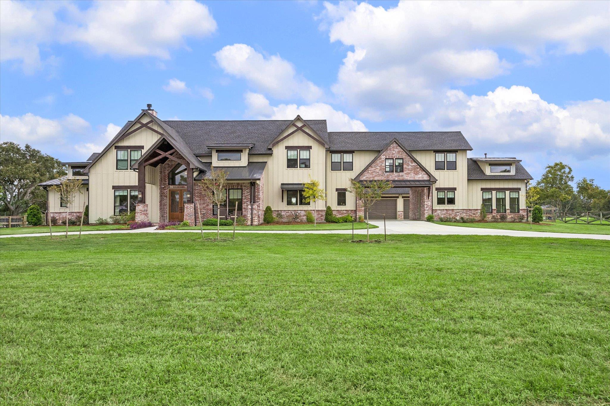 An expansive green lawn leads to a magnificent es