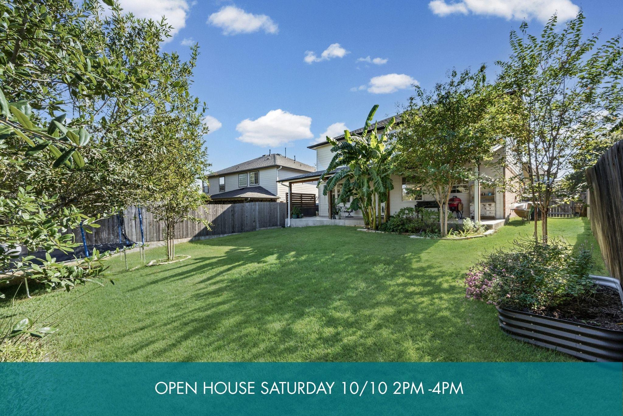Mature trees and privacy fencing frame a spacious