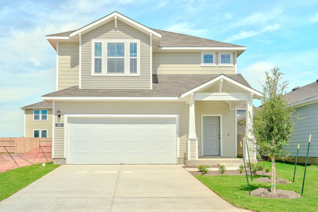 Crisp siding and architectural gables define this
