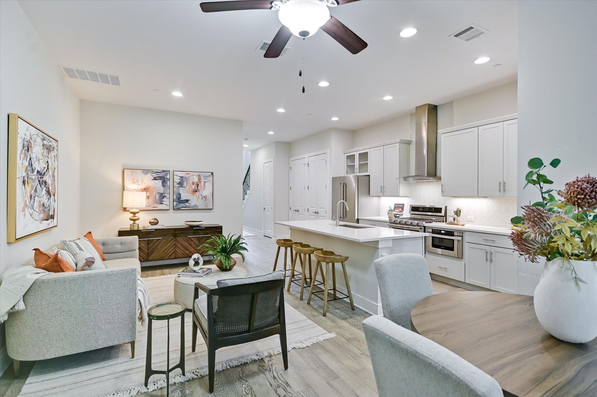 An open floorplan seamlessly connects the invitin