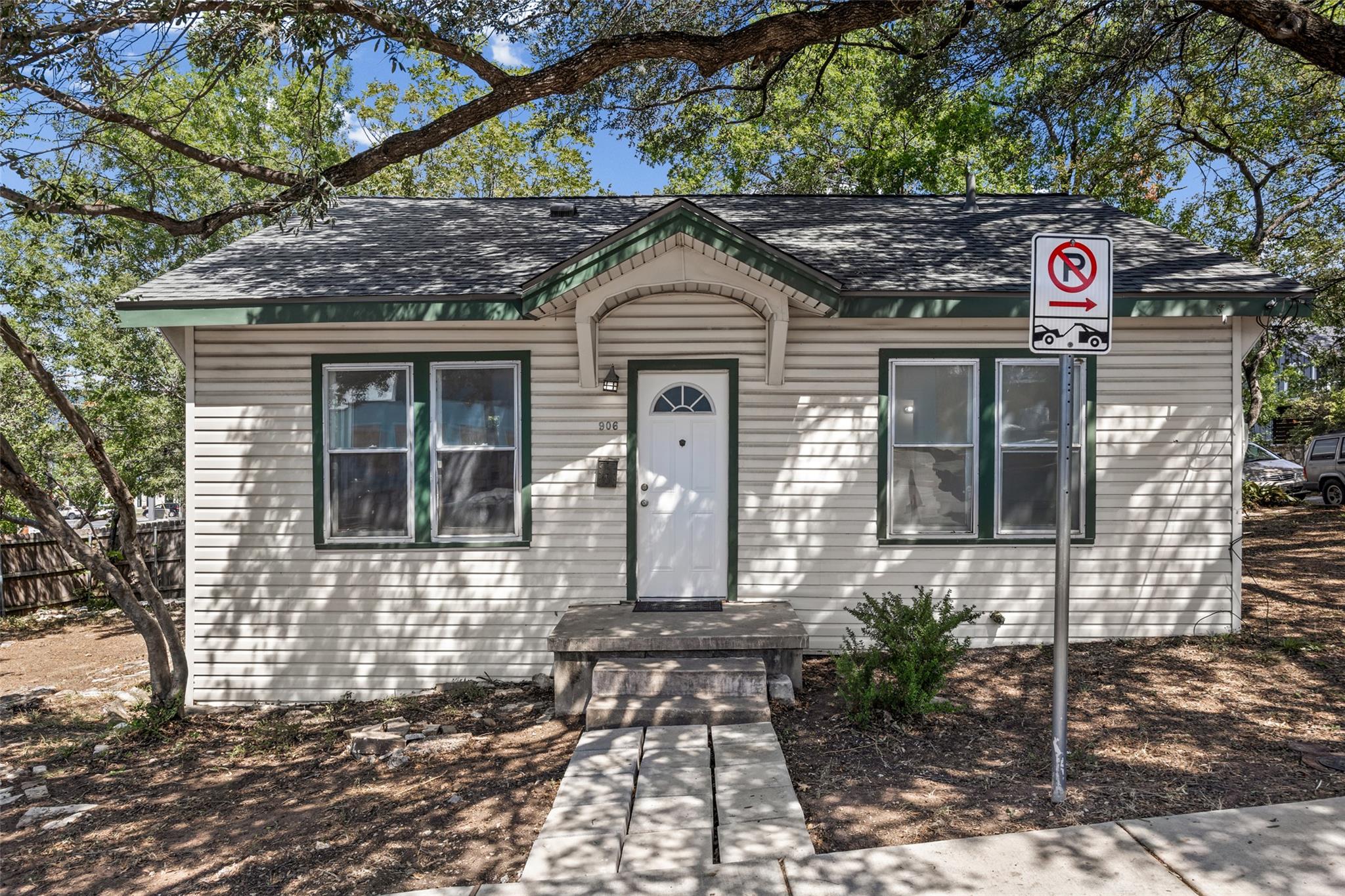 Mature trees shade a classic cottage exterior fea