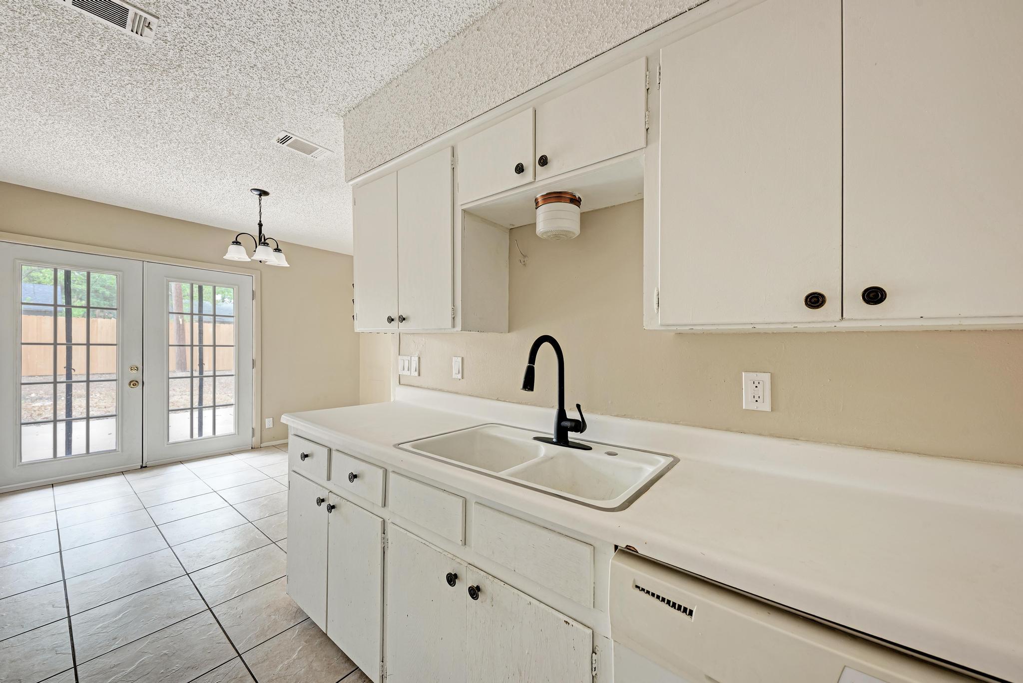 White cabinetry and clean countertops accent this