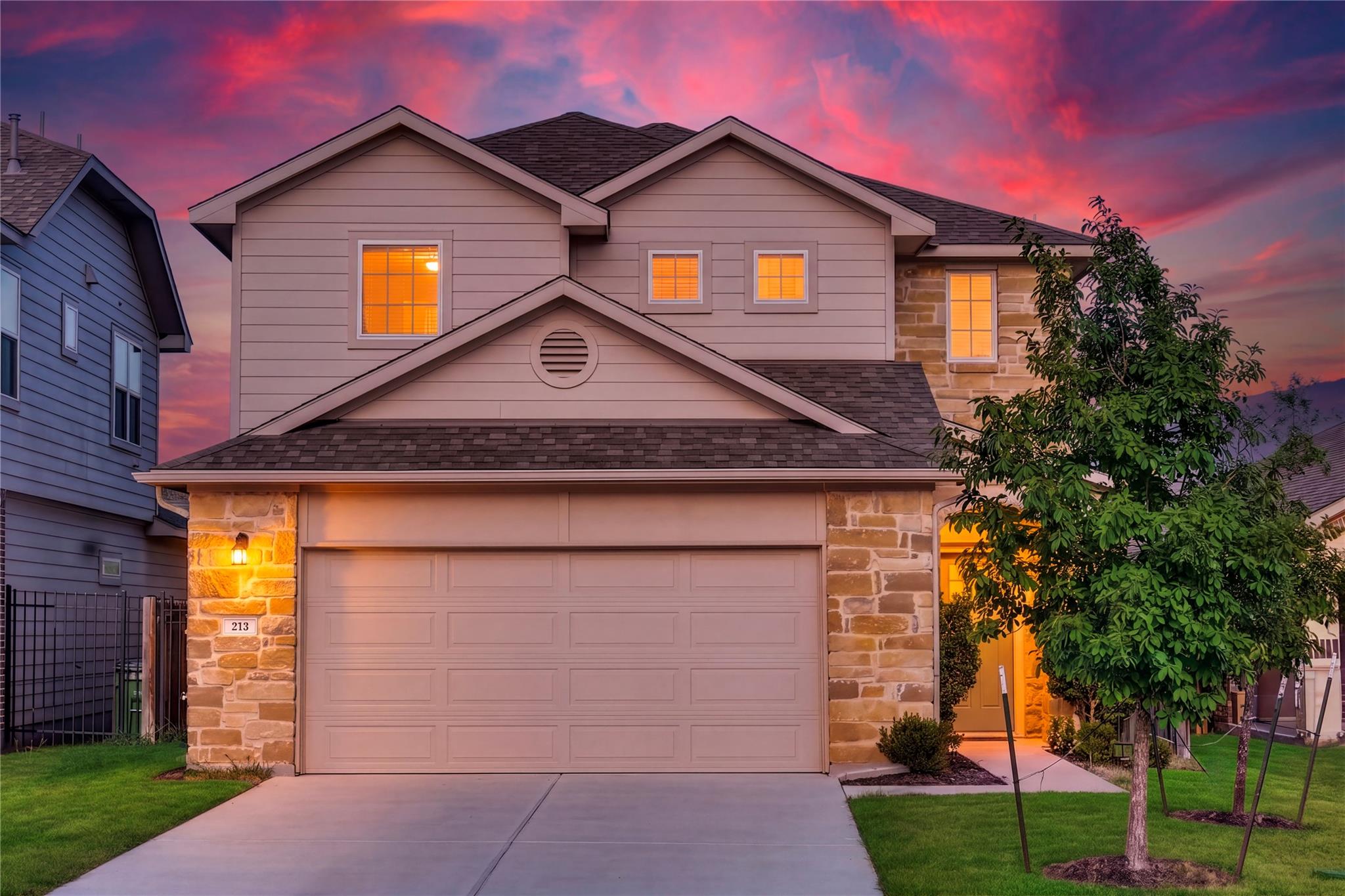 An inviting exterior displays timeless stone acce