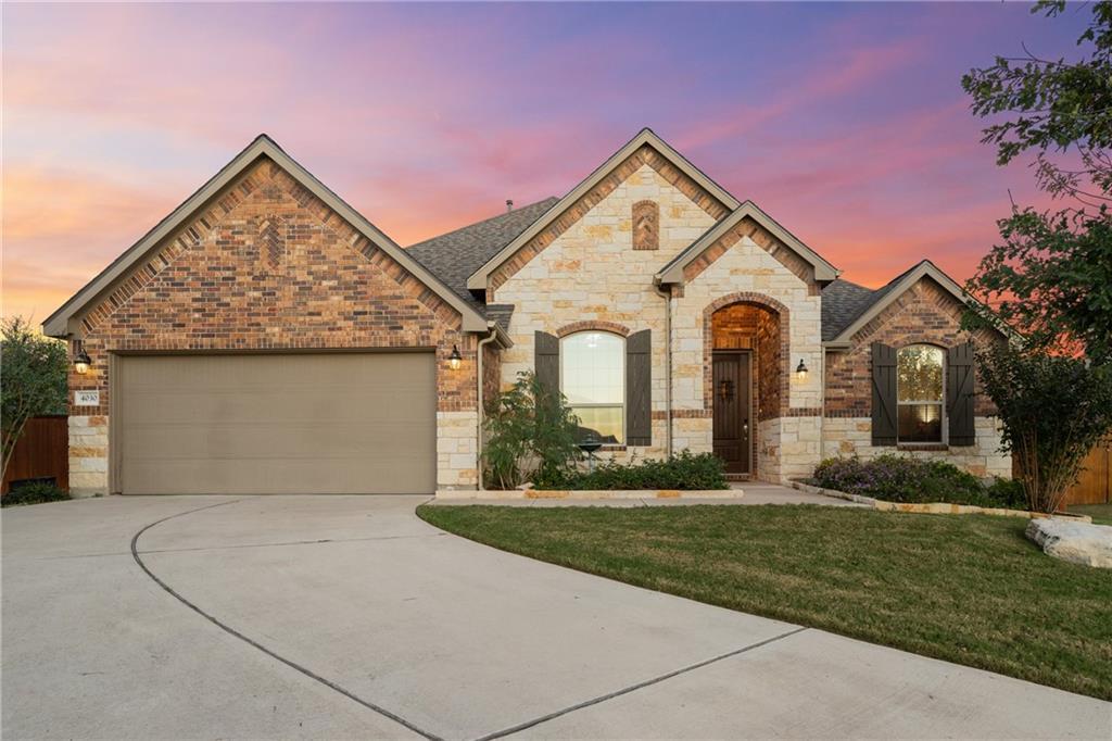 An inviting stone and brick facade accents this b